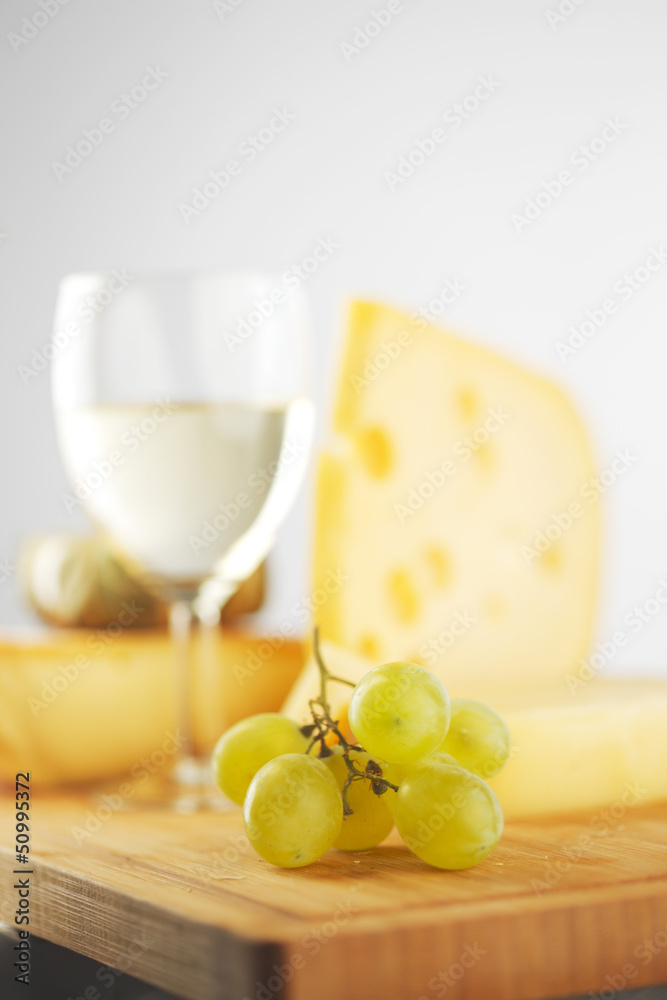 cheese and wine on a wooden table cheese and wine on a wooden table