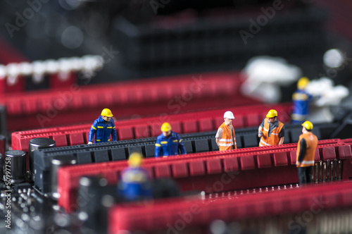 Wallpaper Mural Group of Engineers Fixing Computer Circuit Board Torontodigital.ca