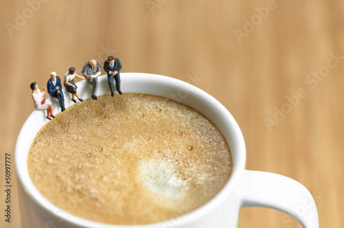 Miniature business team having a coffee break photo