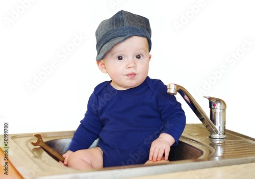 The baby plumber repairs water tap
