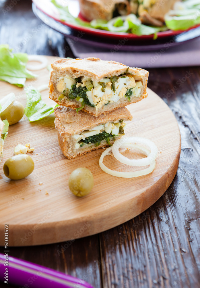 pieces of cake with egg and spinach on the board pieces of cake with egg and spinach on the board