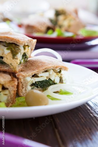 egg-spinach pie cut into pieces