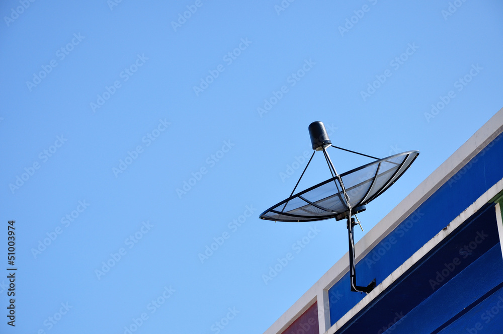 Satellite dish antenna for television on house roof, Thailand.