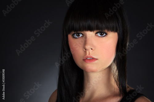 Beautiful Brunette Woman Portrait over Dark Background