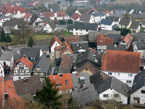 Blick von der Burgruine auf alte Dächer und das romantische hessische Dorf Wettenberg Krofdorf-Gleiberg bei Gießen in Hessen photo