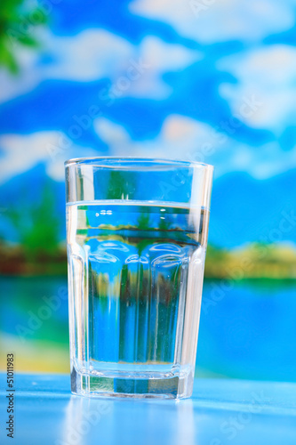 glass of the water on the beach