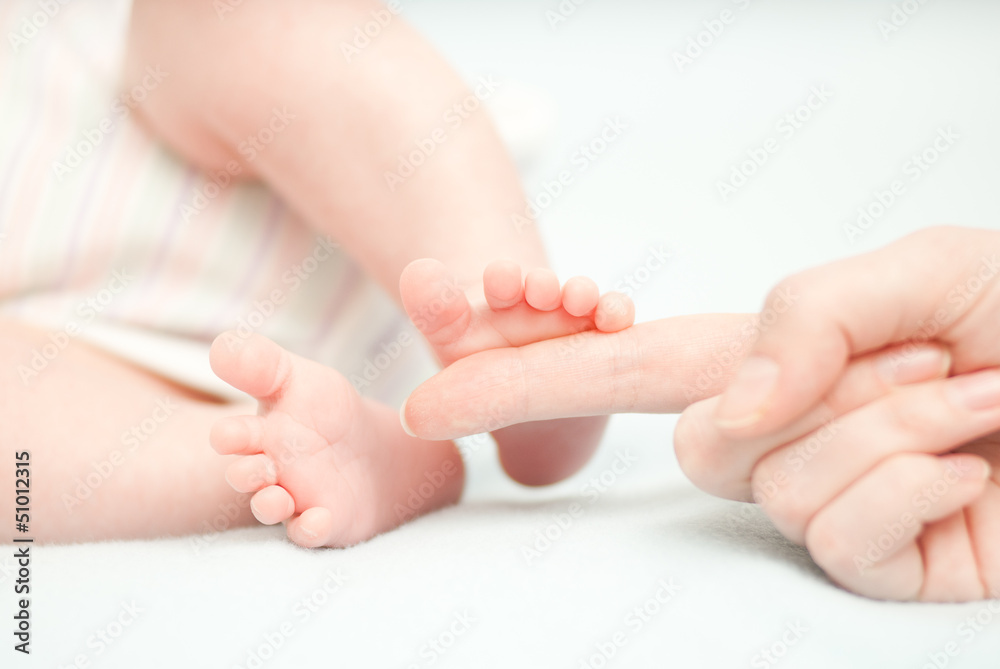 little baby feet and hand of the mother little baby feet and hand of the mother