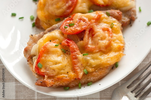 Pork with onion, cherry tomatoes and cheese