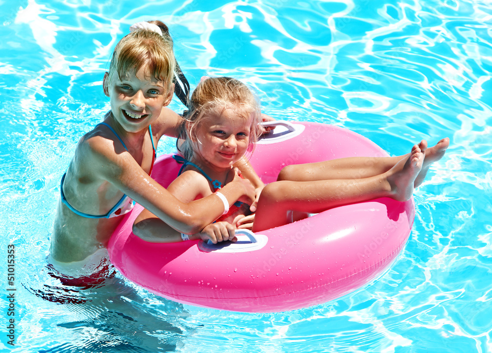 Children sitting on inflatable ring. Children sitting on inflatable ring.