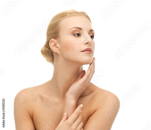 woman touching her face skin