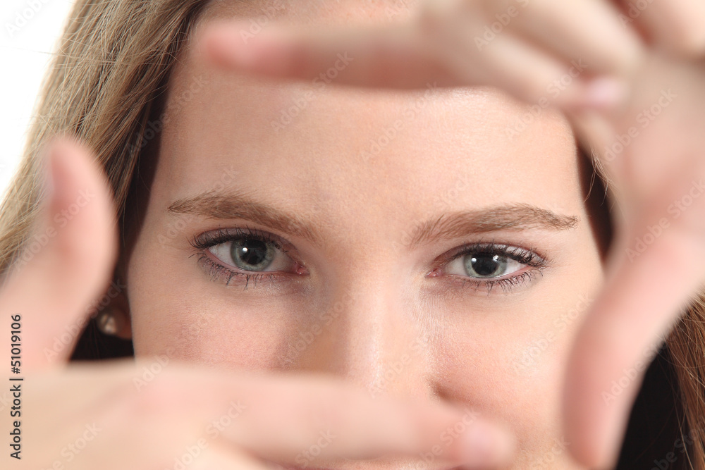 Fototapeta premium Beautiful woman framing her blue eyes with the fingers