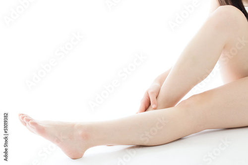 Beautiful young woman legs on white background