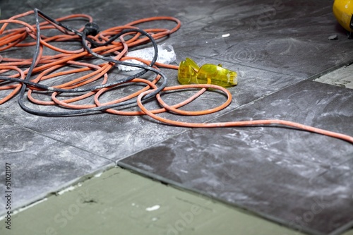 coils of electrical cable lying on floor workplace