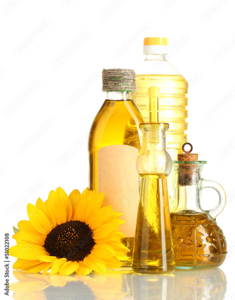 oil in jars and sunflower, isolated on white oil in jars and sunflower, isolated on white