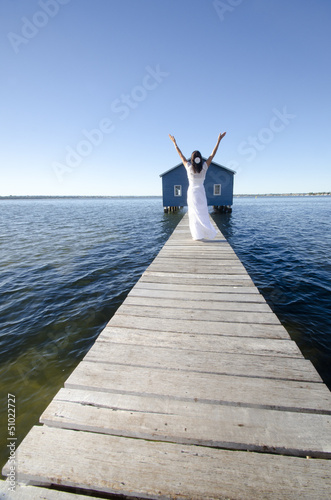 Joyful woman white dress on boardwalk
