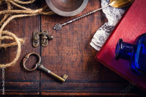 Vintage retro background with key and book over wooden box