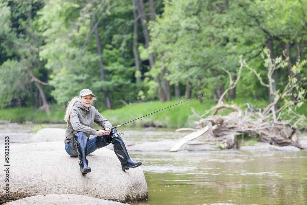woman fishing in Sazava river, Czech Republic