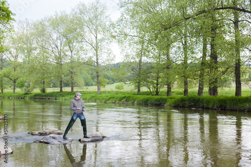 woman fishing in Sazava river, Czech Republic