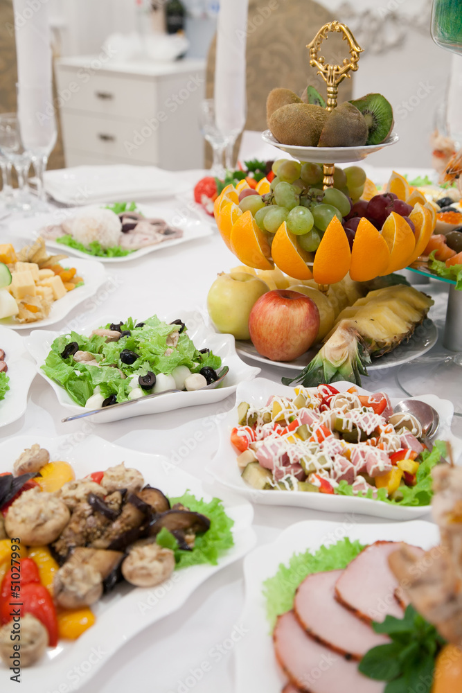 Served table with appetizers in restaurant with fruits Served table with appetizers in restaurant with fruits