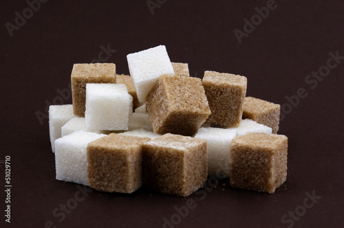 bunch of brown and white lump sugar on a brown background