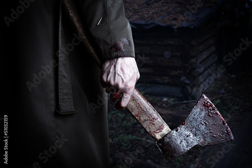 Axe with blood in male hand