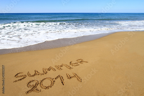 Summer 2014 written on sandy beach