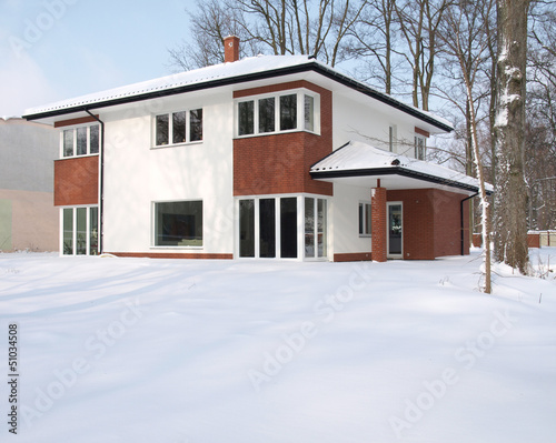 Modern mansion covered with snow