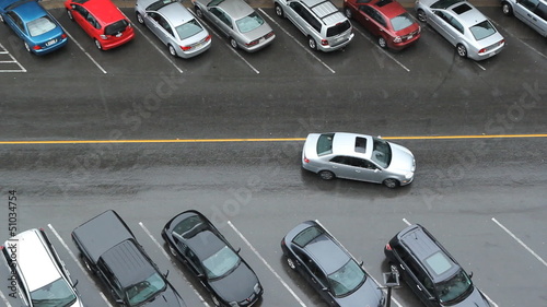 Car finds parking spot. Heavy rain.