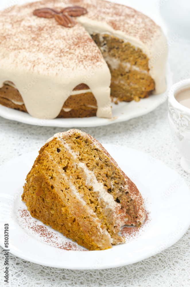 piece of carrots and pumpkin cake with coffee cream on a plate