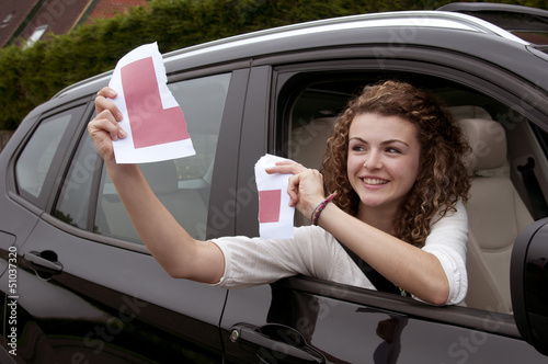 Young female driver holding L learner plate