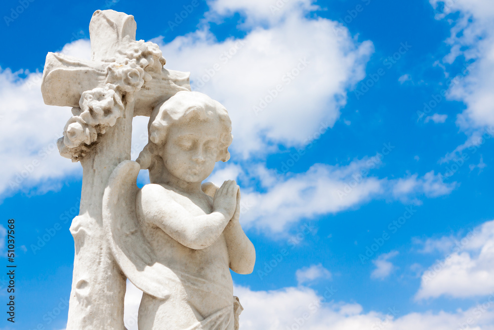 Beautiful infant angel with a blue sky background Beautiful infant angel with a blue sky background