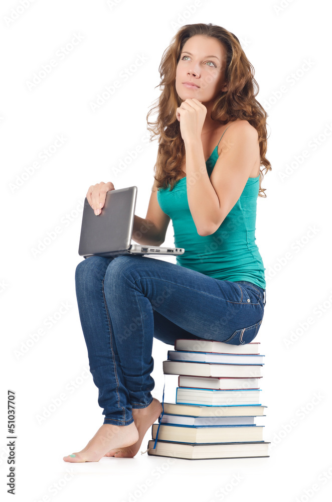 Student with netbook sitting on books Student with netbook sitting on books