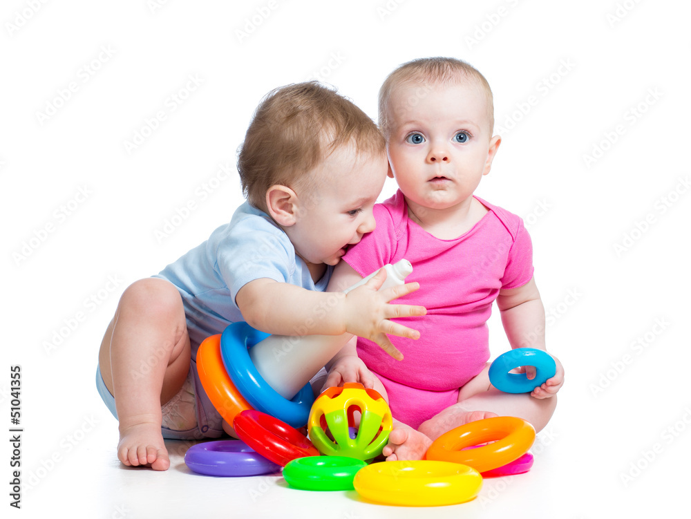 kids boy and girl playing toys together kids boy and girl playing toys together