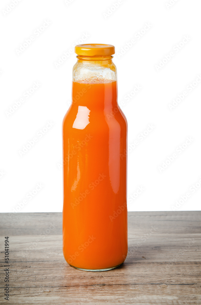 Bottle with carrots juice, it is isolated on white Bottle with carrots juice, it is isolated on white