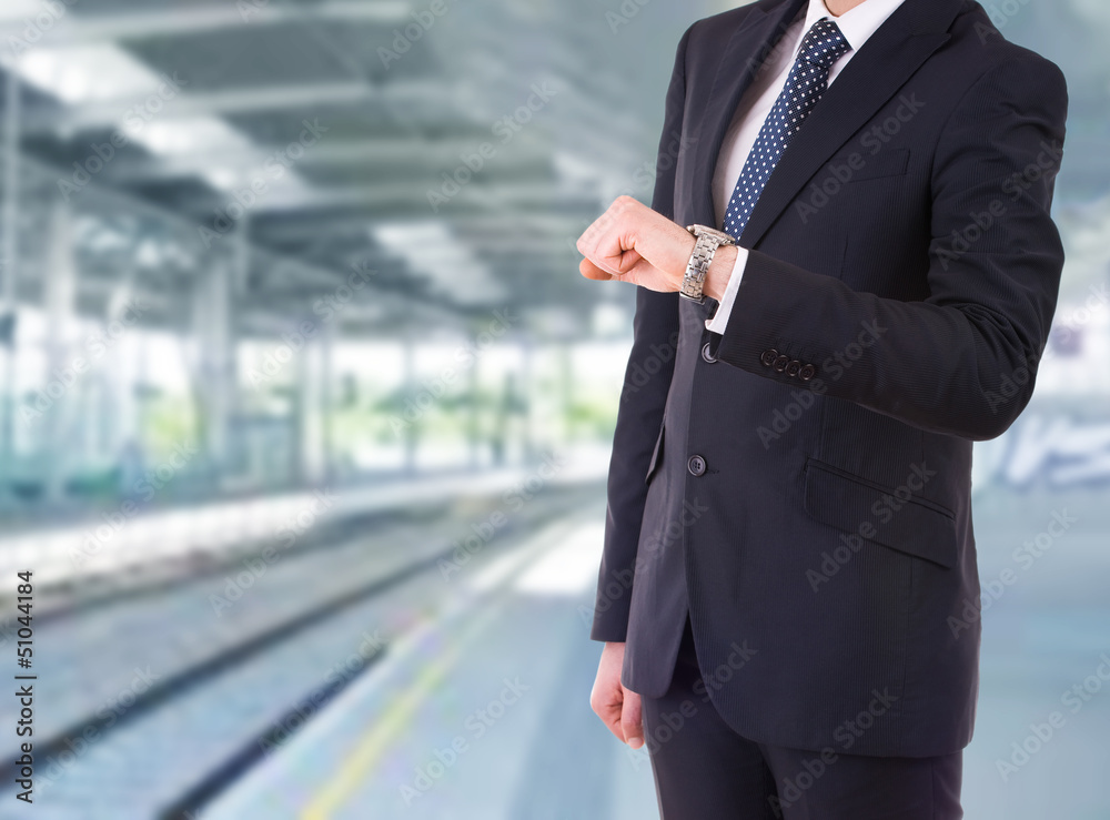 Businessman checking time on his wristwatch. Businessman checking time on his wristwatch.