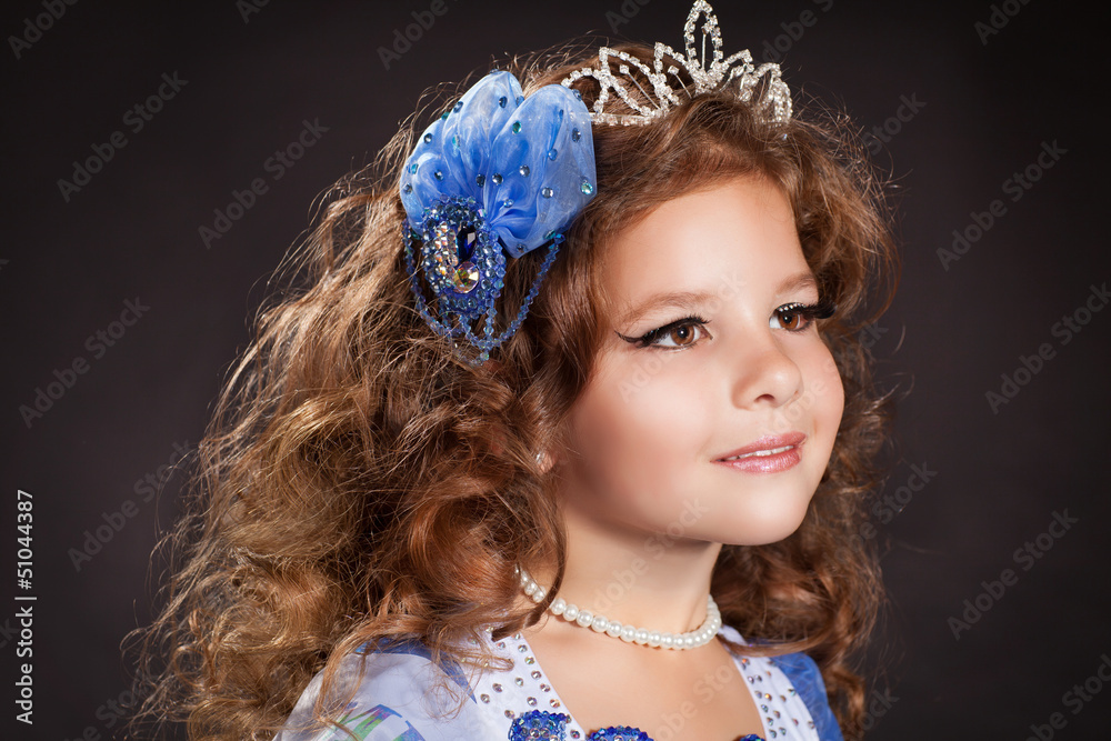 A beautiful bride with long curly hair and a delicate tiara on her head,  which she holds in her hands. Portrait of a girl looking into the lens.  Natural makeup 36426152 Stock