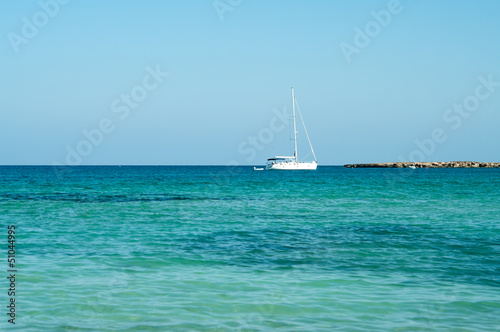 Seashore of Cyprus island with coast and yacht in Mediterranean