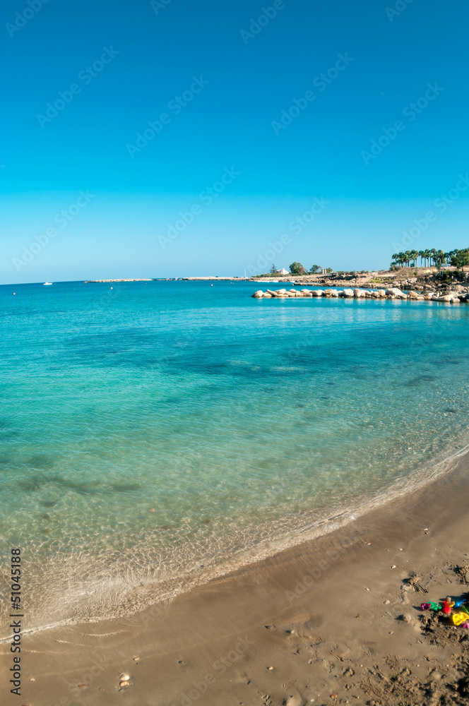 View of empty sandy beach in Cyprus resort, Mediterranean sea