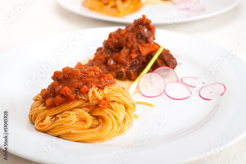 pasta with pork ribbs sauce on polenta bed photo