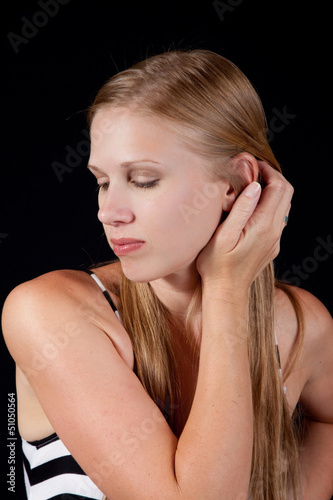 pretty blond in stripped dress, stanind looking left photo