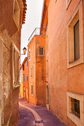 Fototapeta Naklejka Na Ścianę i Meble -  Roussillon village, urban street and red facades. Provence