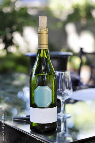 White wine bottle on table photo