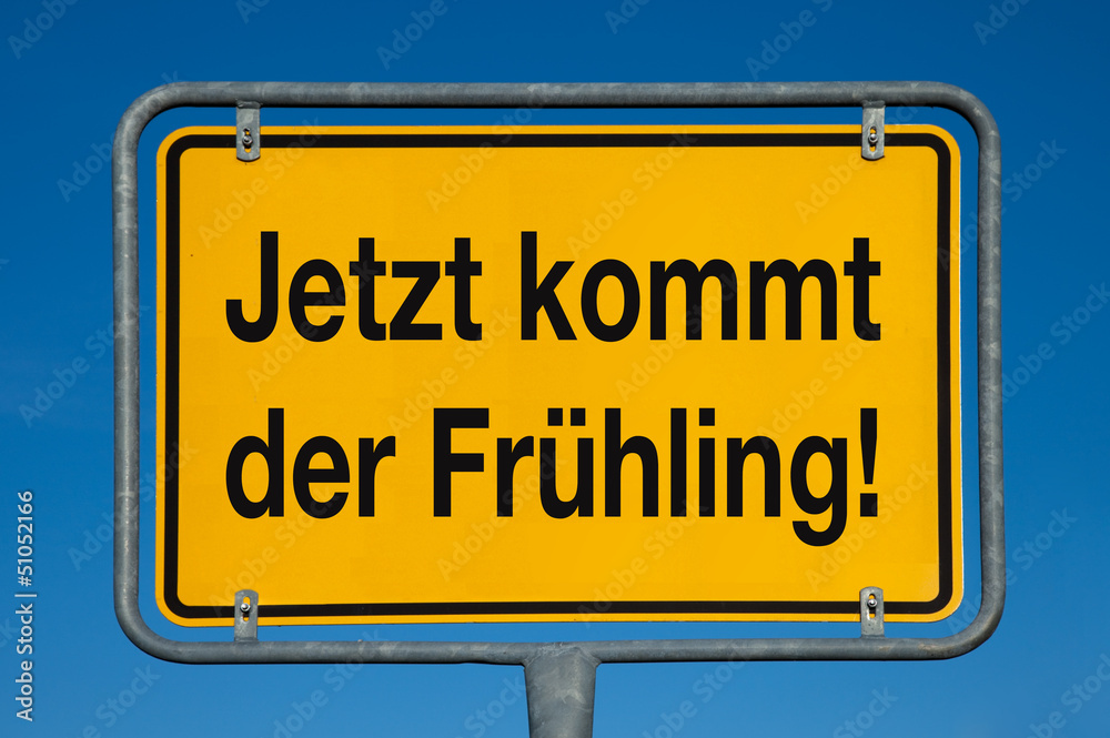 Ortsschild mit blauem Himmel JETZT KOMMT DER FRÜHLING! Ortsschild mit blauem Himmel JETZT KOMMT DER FRÜHLING!
