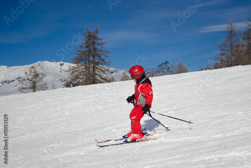 Child skiing in a sunny day