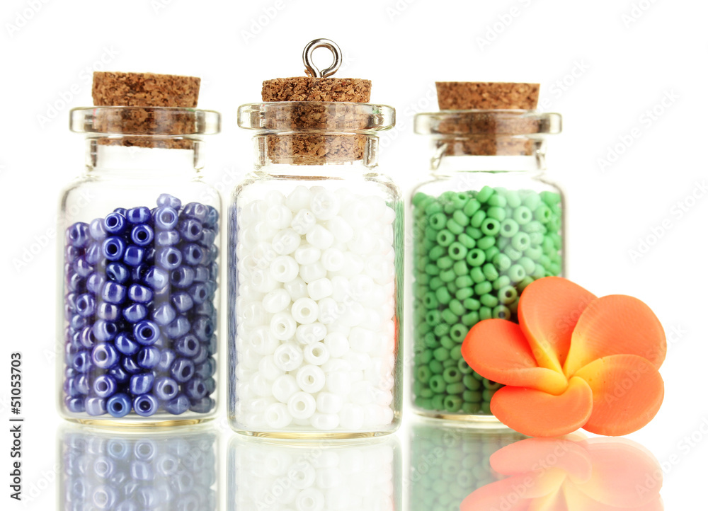 Little bottles full with colorful beads isolated on white Little bottles full with colorful beads isolated on white
