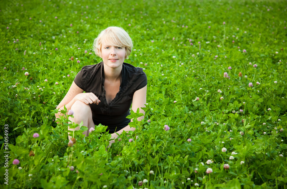 Girl in a field of flowers looking at the camera Girl in a field of flowers looking at the camera