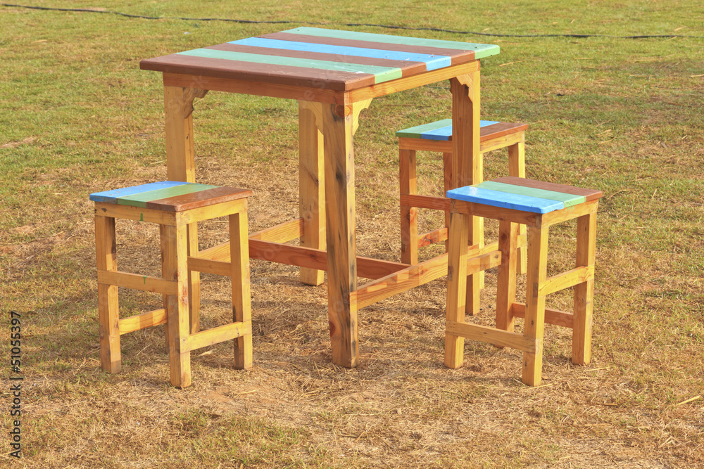 Wooden table and chairs in garden Wooden table and chairs in garden