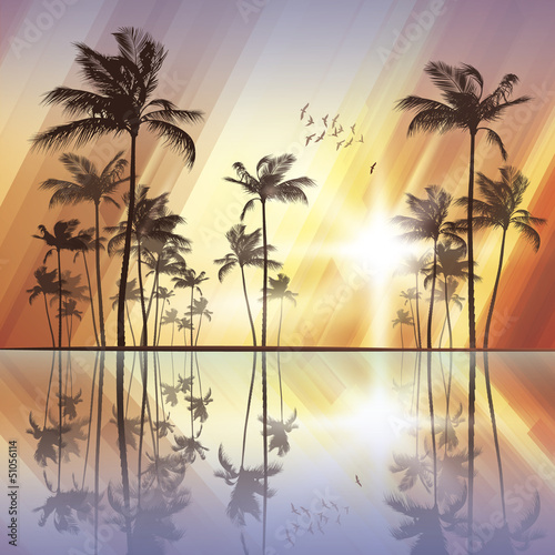 Fototapeta Naklejka Na Ścianę i Meble -  Palm trees at sunset with reflection in water