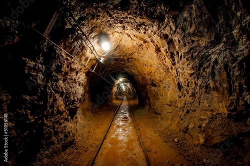 Underground mine passage with rails photo