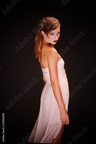 Young woman against dark background